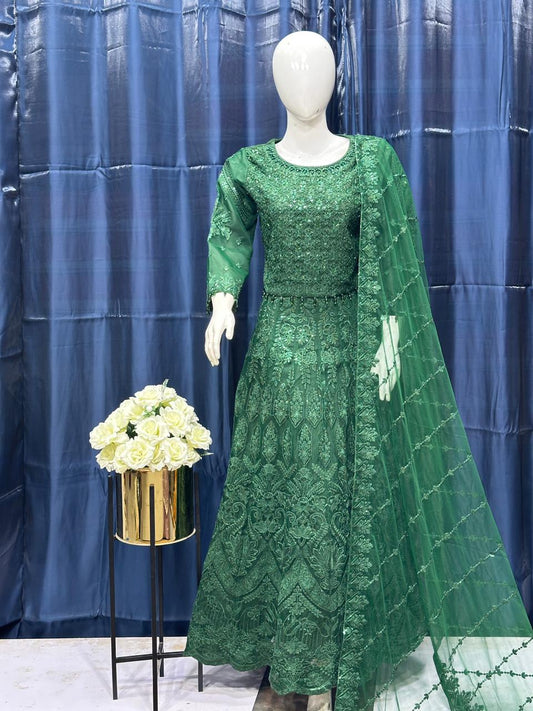 Green lace dress on a mannequin with a blue curtain background